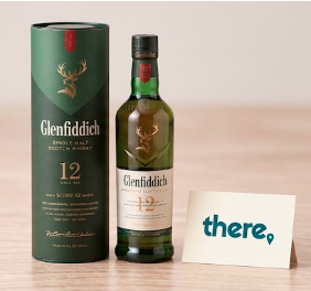 A bottle of Glenfiddich whisky with a personalised THERE card